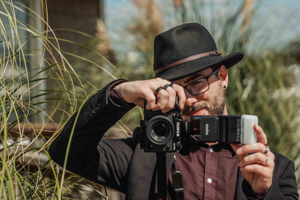 Erik Davidson holding a camera outdoors