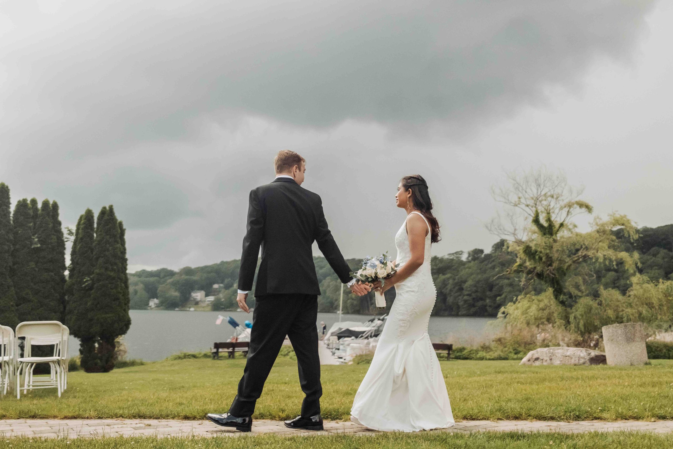 Wedding couple walking along the water