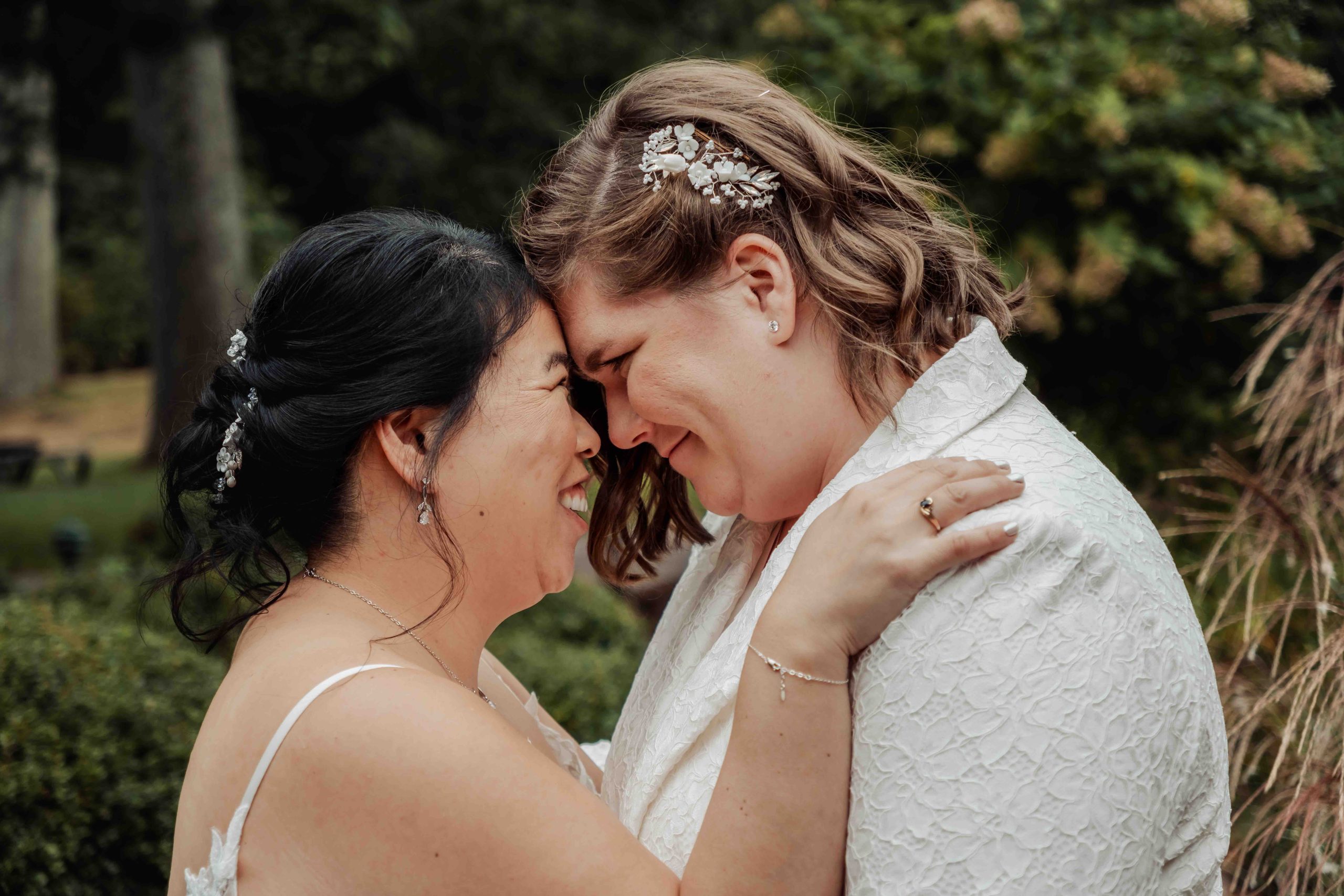 Two brides embracing outdoors